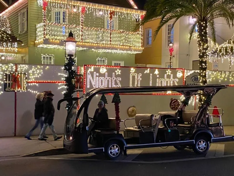 An electric cart under holiday lights, an alternative to St. Augustine carriage tours, Florida