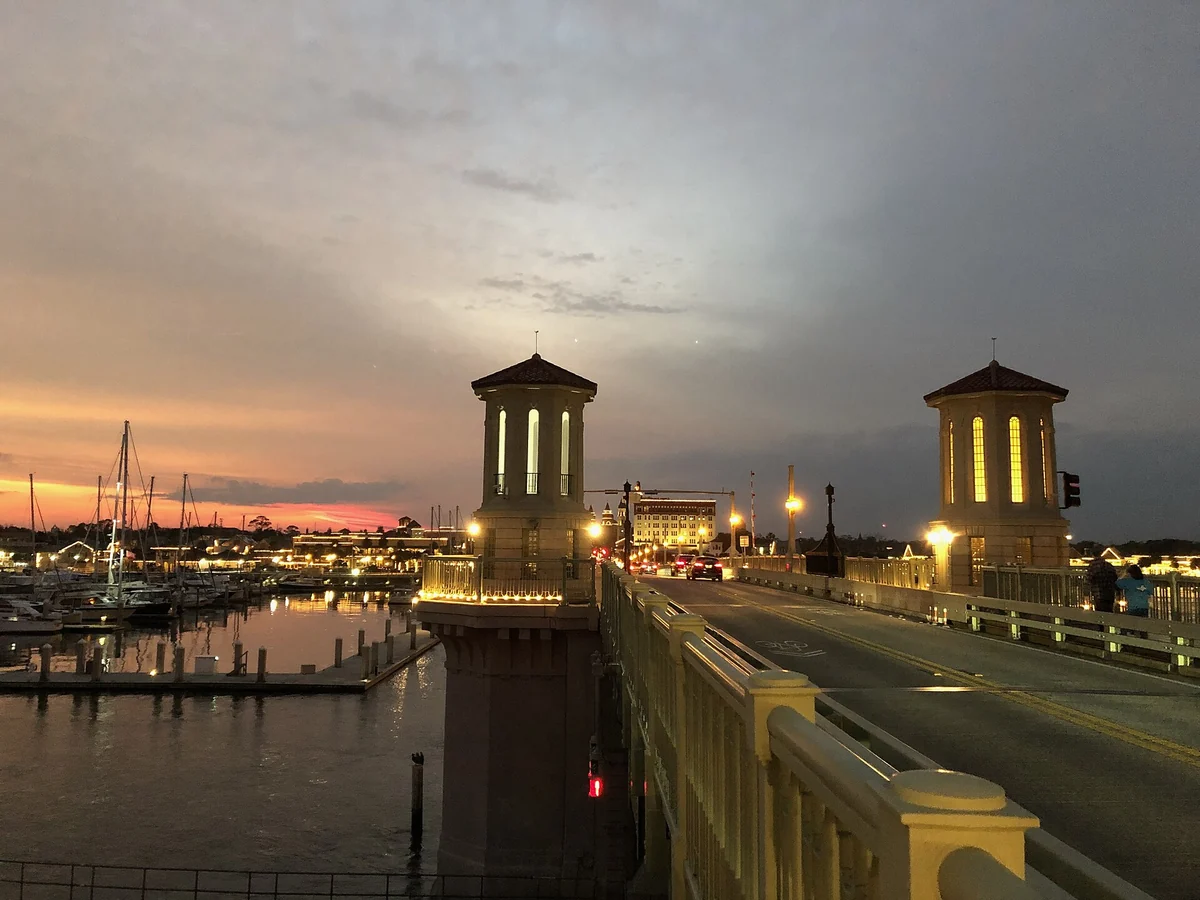 The Bridge of Lions towers lit at sunset over Matanzas Bay, at the bayfront end of St. Augustine carriage tours